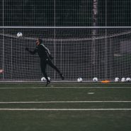 a couple of people on a field with a soccer ball