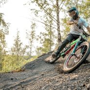 a man riding a bike down a dirt road