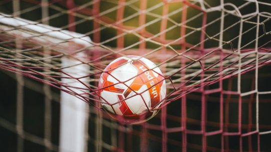 Soccer ball stuck in the goal net
