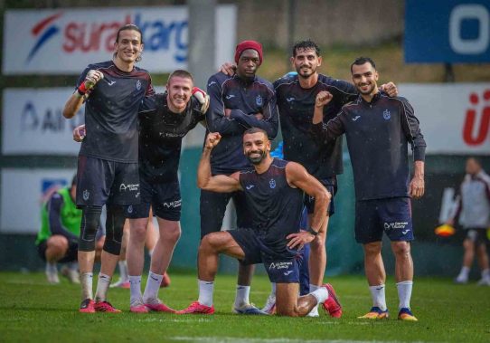 Trabzonspor futbolcuları yağmurlu antrenmanda gülümseyerek toplu poz verirken