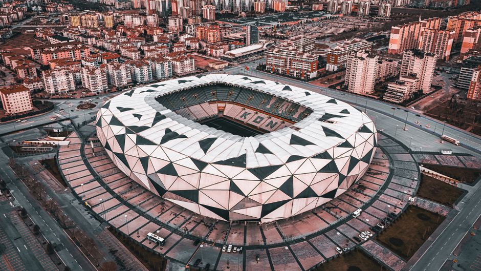 A stunning aerial view of the geometric design of Konya Stadium in Türkiye, showcasing urban architecture.