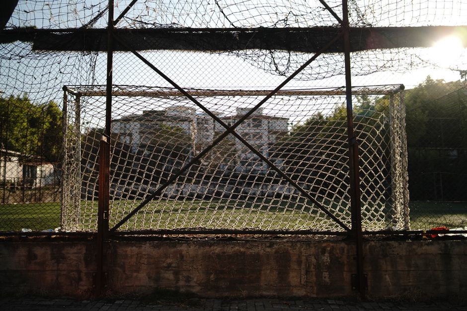 Rustic soccer goal framed in metal and netting under the warm Istanbul afternoon sun.